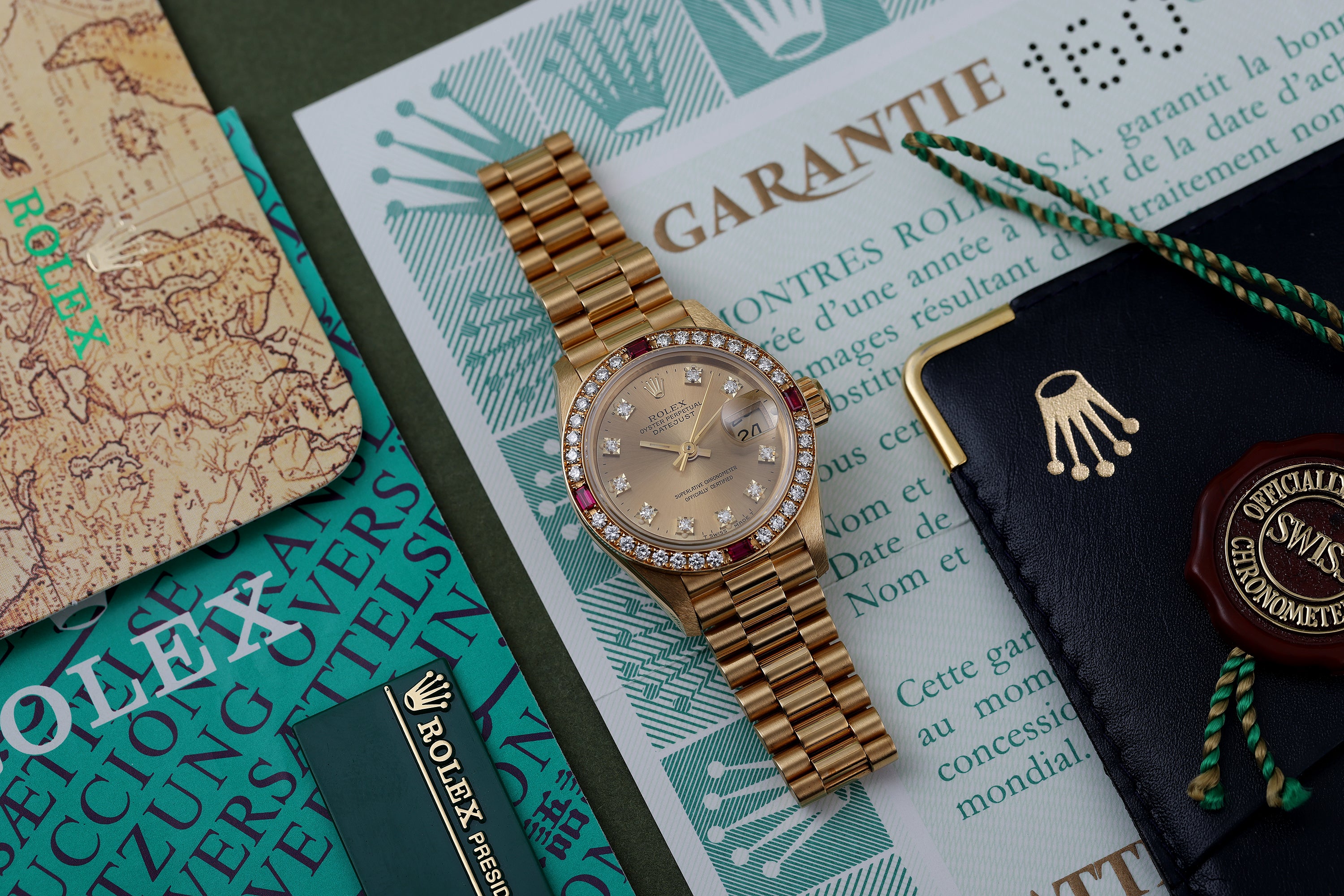 NOS: Rolex Lady DateJust | Diamond & Ruby Dial Bezel | 18k Yellow Gold | 69068 | Unpolished